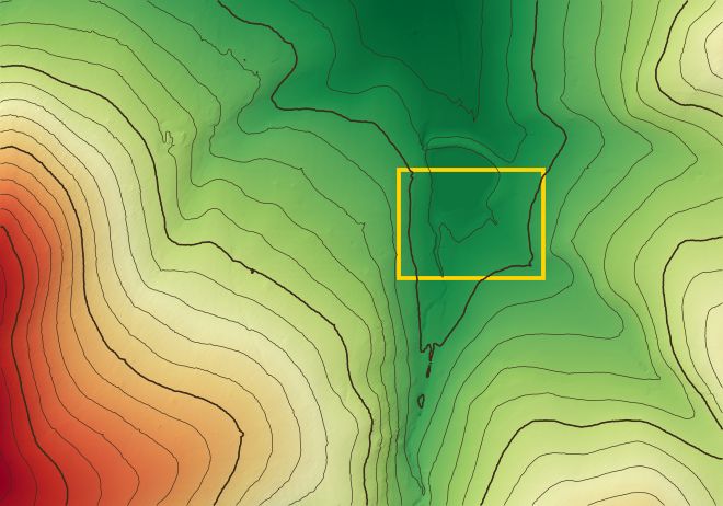 Elevation from low (green) to high (red) with contour lines over a hillside, and the block outlined in yellow.