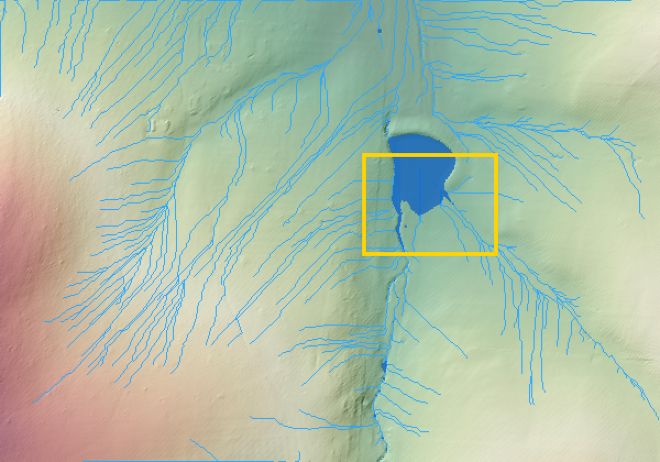 Blue lines showing where surface water runs across rolling ground, and a blue patch where it ponds at a farm dam.